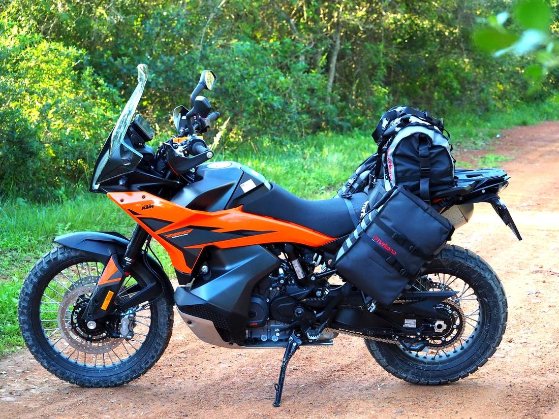 KTM 790 Adventure motorcycle fully equipped with luggage panniers, parked on a Eastern Cape gravel road
